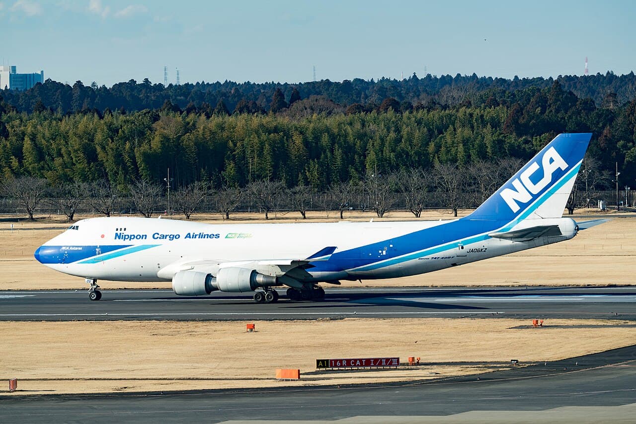 A Nippon Cargo Airlines freighter at Tokyo Narita Airport — the kind of air freight that carries proxy and retailer parcels from Japan to overseas collectors, now subject to US duty on arrival regardless of value